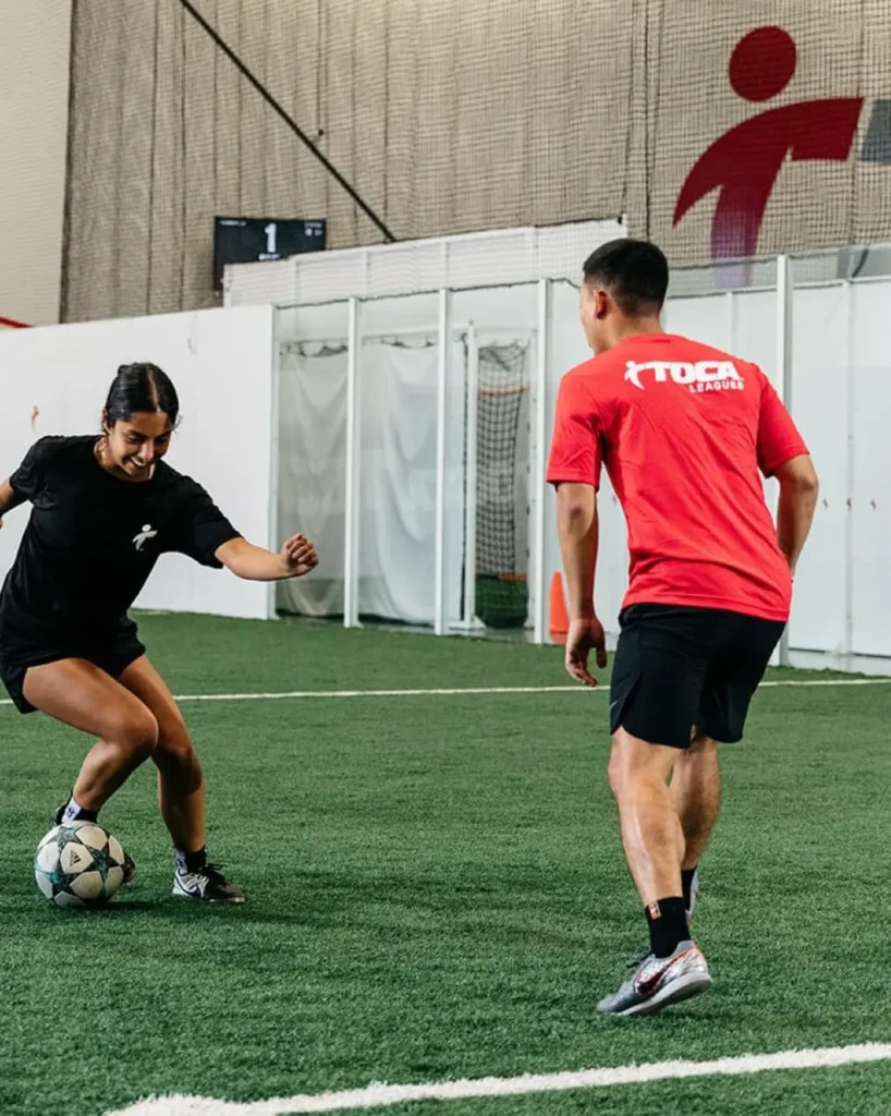 A boy and girl playing football